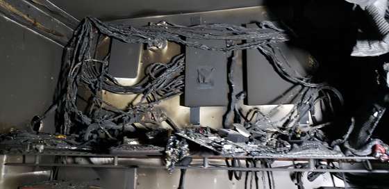 Charred ceiling and wiring above the office floor